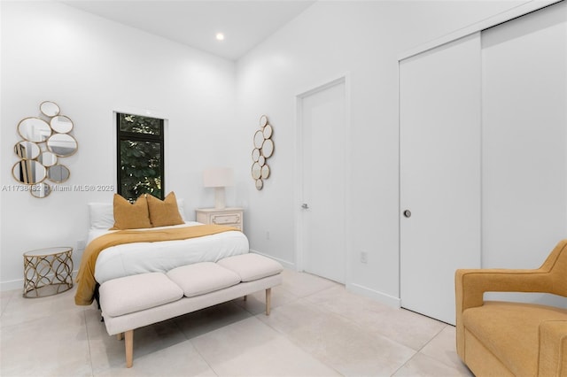 bedroom featuring light tile patterned floors and a closet