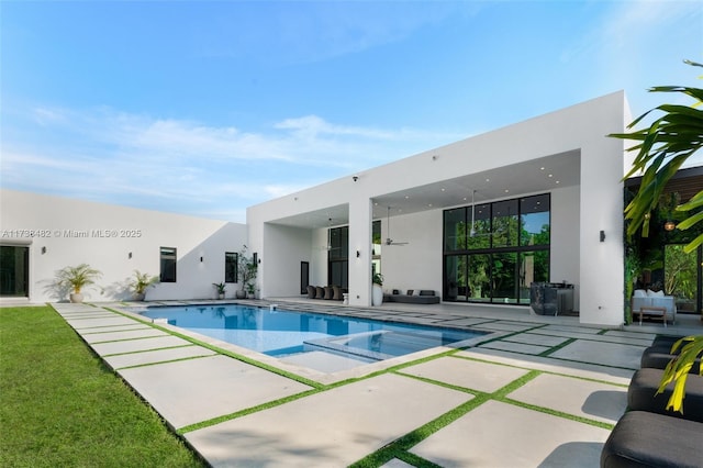 view of pool with outdoor lounge area, a patio, and an in ground hot tub