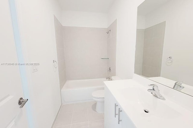 full bathroom featuring tiled shower / bath, vanity, tile patterned floors, and toilet