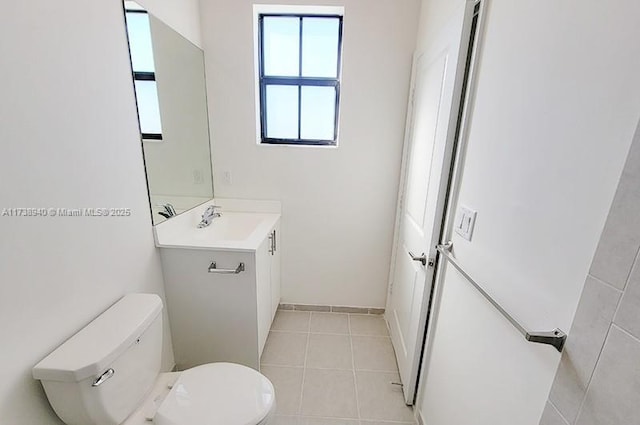 bathroom with vanity, toilet, and tile patterned flooring