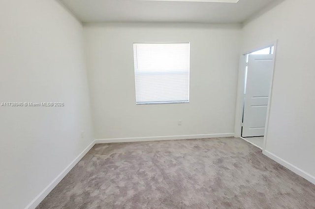 unfurnished room with light colored carpet