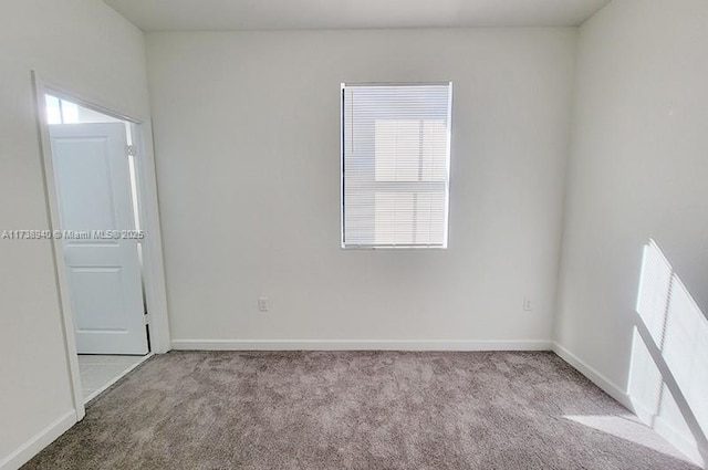 unfurnished room featuring light colored carpet