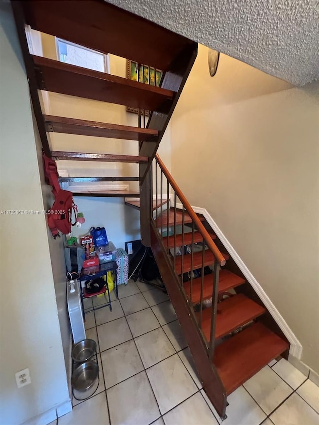 stairs with tile patterned flooring