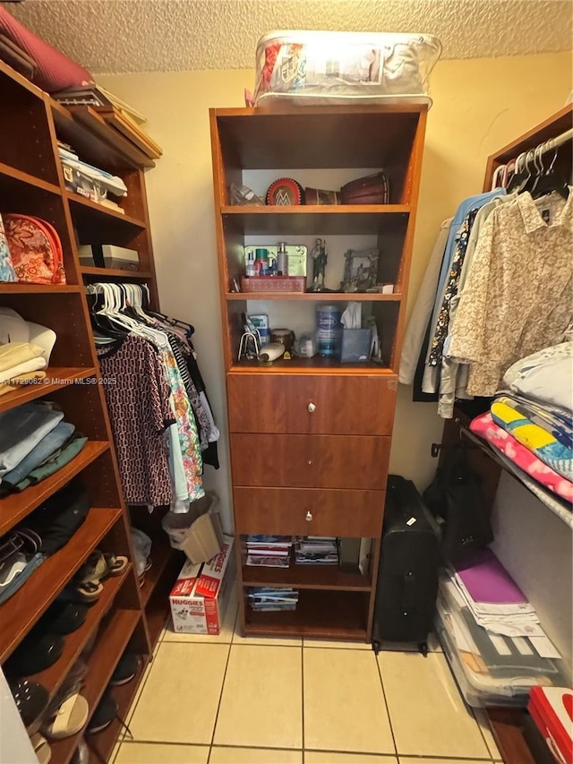 walk in closet with tile patterned floors