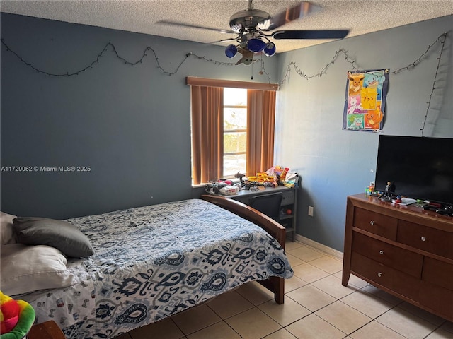 tiled bedroom featuring ceiling fan and a textured ceiling