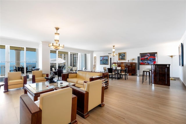 living room featuring an inviting chandelier and light wood-type flooring