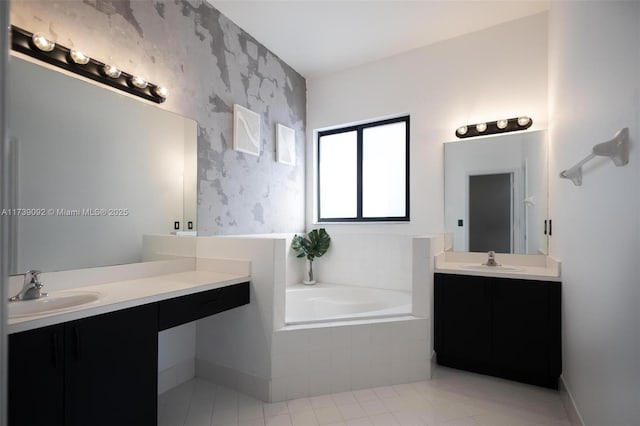 bathroom with vanity and tiled tub