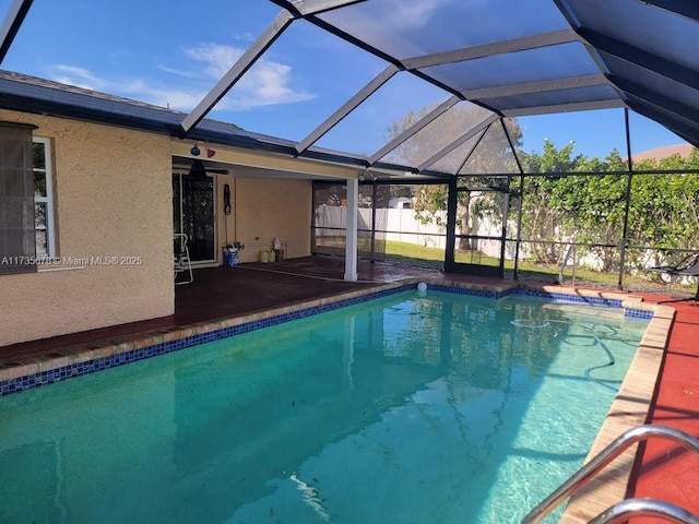 view of swimming pool with a lanai and a patio area