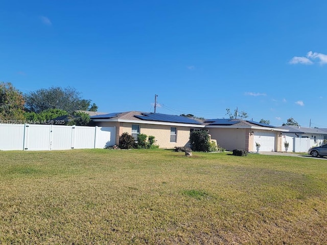 view of front of home with a front lawn and solar panels