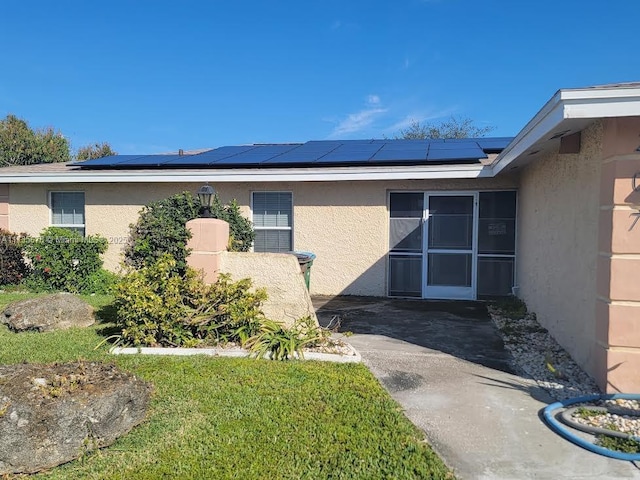 view of side of home with solar panels