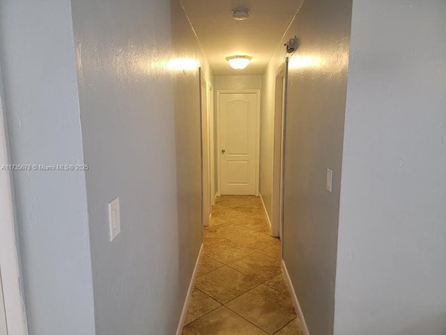 hall with light tile patterned floors