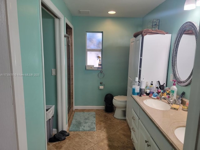 bathroom featuring vanity, toilet, an enclosed shower, and tile patterned flooring