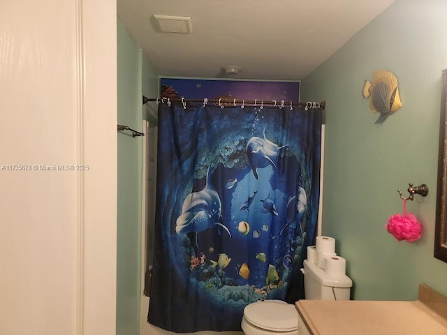 bathroom featuring vanity, a shower with shower curtain, and toilet