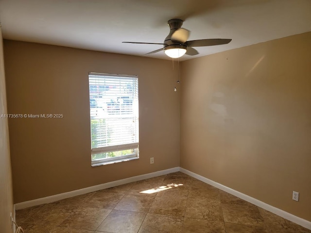 tiled spare room with ceiling fan