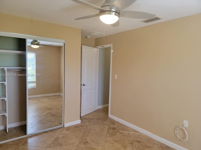 unfurnished bedroom with ceiling fan, a closet, and light tile patterned floors