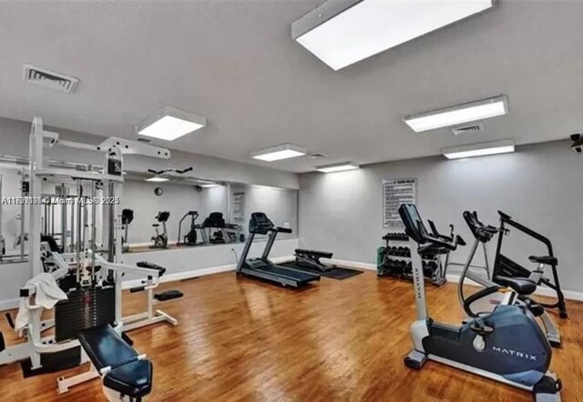 gym with hardwood / wood-style floors