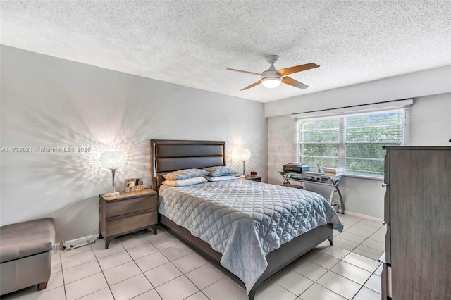 tiled bedroom featuring a textured ceiling and ceiling fan