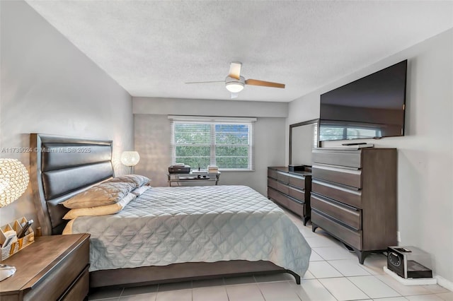 bedroom with ceiling fan, a textured ceiling, and light tile patterned floors