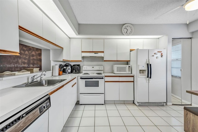 kitchen featuring white cabinetry, white appliances, sink, and light tile patterned floors