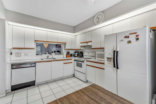 kitchen featuring white cabinetry, white appliances, sink, and light tile patterned floors