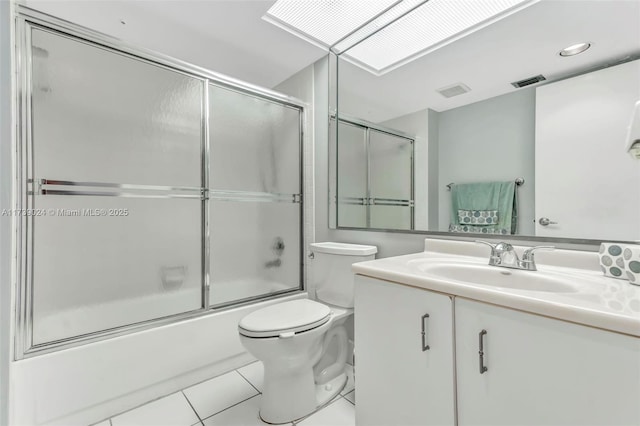 full bathroom featuring vanity, toilet, tile patterned flooring, and combined bath / shower with glass door