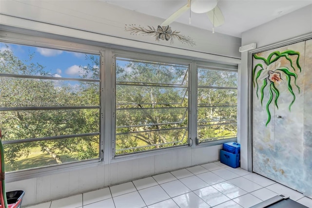 unfurnished sunroom with ceiling fan and a healthy amount of sunlight