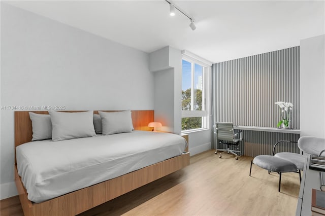 2127 Brickell Ave Unit 705, Miami, FL 33129 - bedroom featuring track lighting and light wood-type flooring