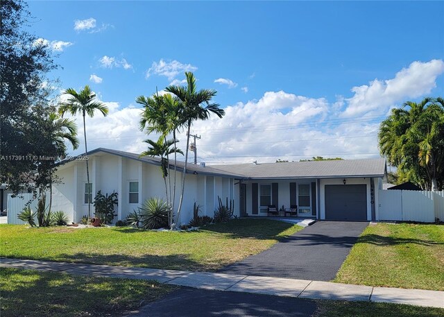 view of front of home featuring a porch, a garage, and a front lawn