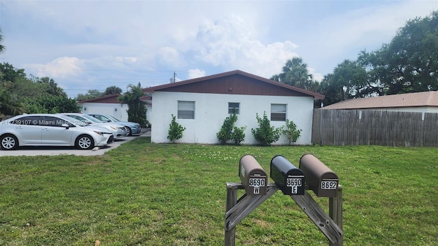 view of side of home featuring a lawn