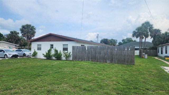 view of side of property with a lawn