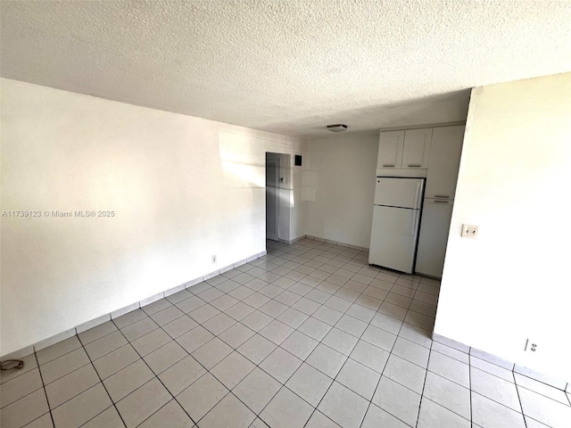 2145 Pierce St Unit 105, Hollywood, FL 33020 - empty room featuring light tile patterned floors and a textured ceiling
