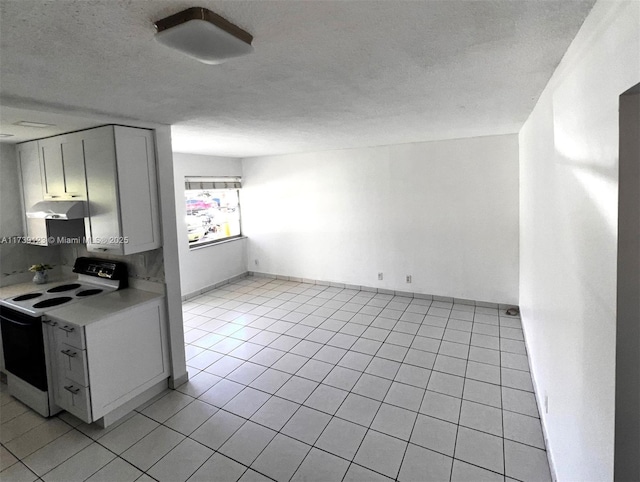 2145 Pierce St Unit 105, Hollywood, FL 33020 - kitchen with under cabinet range hood, light tile patterned floors, light countertops, and white electric range oven