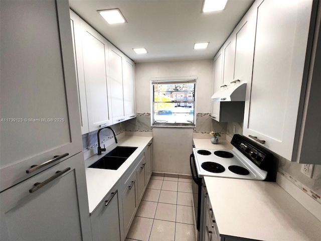 2145 Pierce St Unit 105, Hollywood, FL 33020 - kitchen featuring light tile patterned floors, under cabinet range hood, range with electric cooktop, decorative backsplash, and a sink