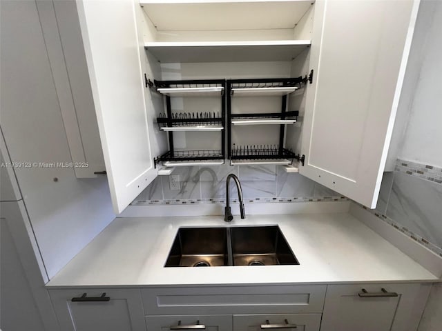 2145 Pierce St Unit 105, Hollywood, FL 33020 - details with tasteful backsplash, a sink, open shelves, and gray cabinets