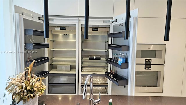 details featuring stainless steel oven and white cabinets