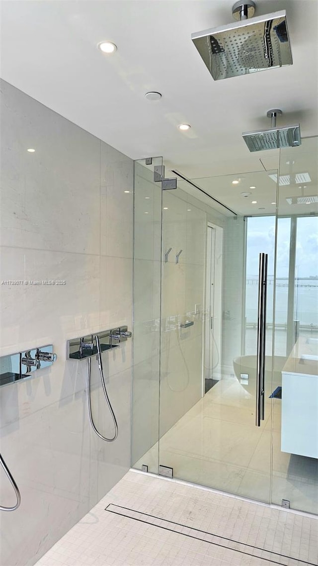 bathroom with a shower with door