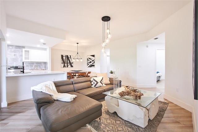 living room with sink and light hardwood / wood-style floors