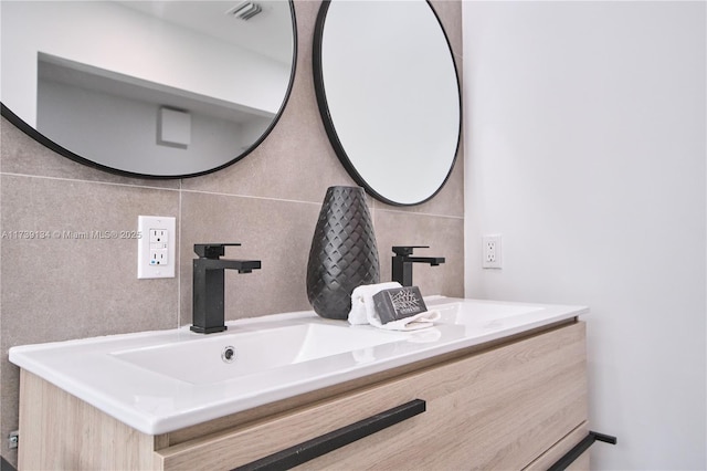 bathroom with vanity and tile walls