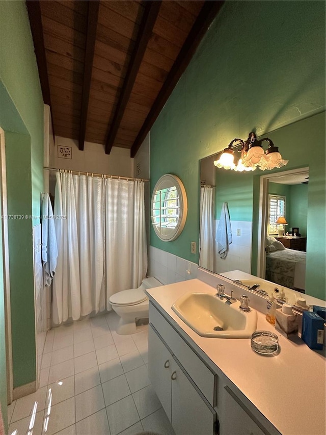 ensuite bathroom featuring vaulted ceiling with beams, connected bathroom, vanity, tile patterned flooring, and wooden ceiling