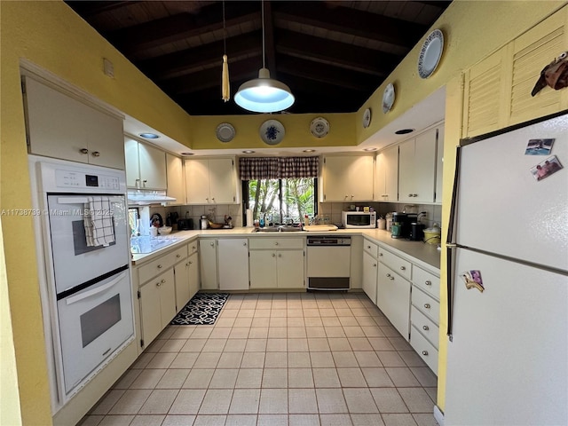 kitchen with light countertops, white appliances, white cabinetry, and tasteful backsplash