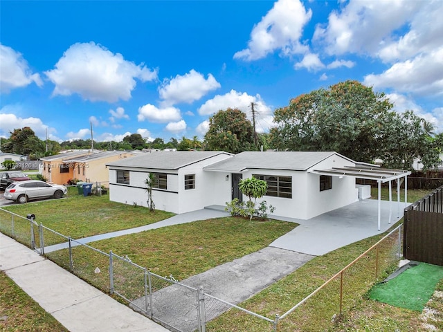 view of front of home with a front lawn and a carport