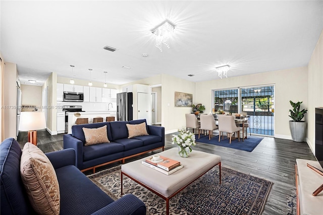 living room with dark hardwood / wood-style flooring