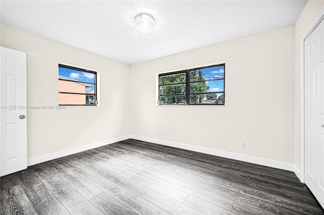 unfurnished bedroom featuring a closet and dark hardwood / wood-style floors