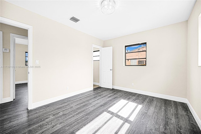 empty room featuring dark wood-type flooring