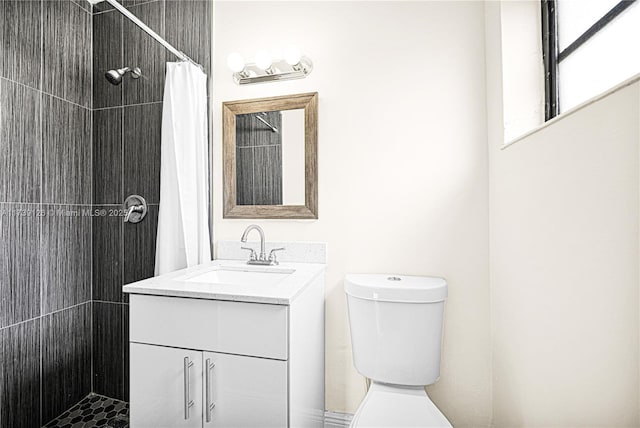 bathroom with vanity, toilet, and walk in shower