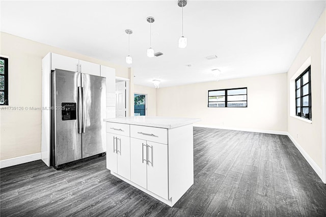 kitchen with pendant lighting, dark hardwood / wood-style floors, white cabinets, and stainless steel refrigerator with ice dispenser