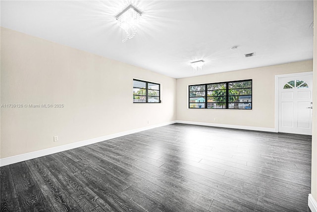 empty room with dark hardwood / wood-style floors