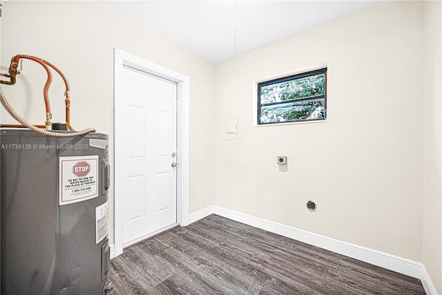 laundry room featuring water heater, dark hardwood / wood-style floors, and hookup for an electric dryer