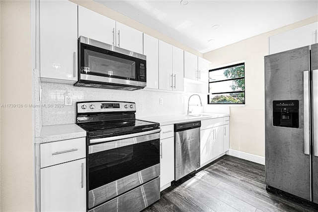 kitchen featuring white cabinetry, appliances with stainless steel finishes, sink, and backsplash