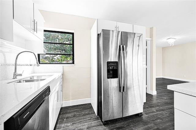 kitchen featuring stainless steel appliances, white cabinetry, sink, and dark hardwood / wood-style floors